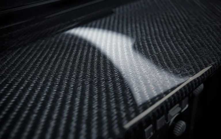 Close-up of carbon fiber hydro dipped dashboard trim showing glossy weave pattern
