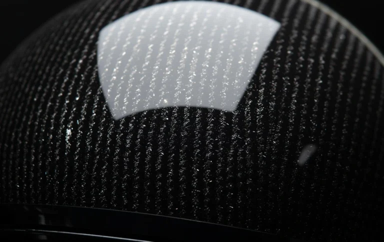 Close up of carbon fiber helmet hydro dipping design with glossy finish